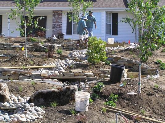 Pathway up front embankment, dry stream bed, dry stack retaining walls landscaping