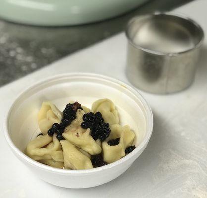 Fermented carrot tortellini with brown butter and pickled blackberry.