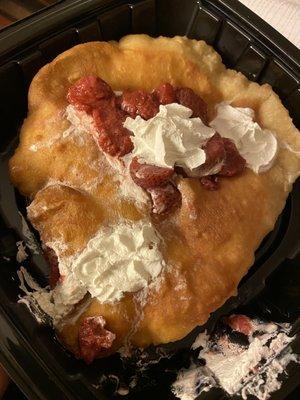 Sopapilla with whipped cream and strawberries