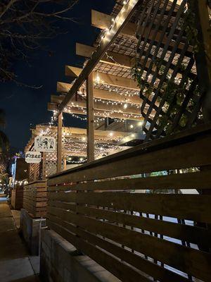 Outside entrance at night. Bright and comfy.