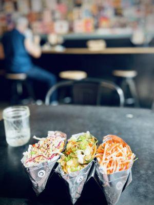 Three delicious tacos sitting in their holder just waiting for me to make a mess