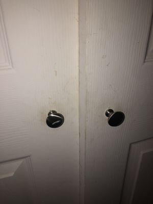 Filthy and warped closet doors with no hangers