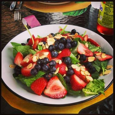 Summer salad with strawberries, blueberries, and sliced almonds