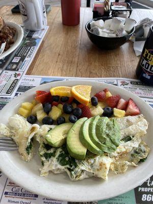 Egg white omelette with spinach, Swiss cheese, avocado, and fresh fruit