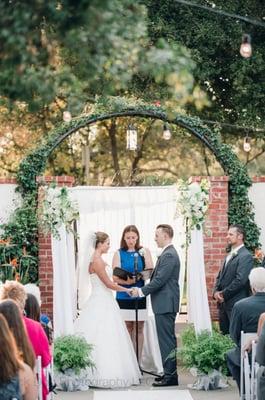 Chuppah set up. They set up a PCV pipe frame, and arranged the flowers, ferns, and fabric.