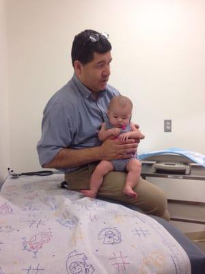 Dr. Sepulveda answering questions while comfortably holding our baby who's comfortable with him and Dr. Gee-Lew.