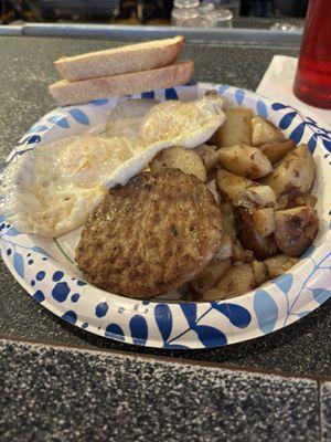 Two eggs over medium with sausage and home fries