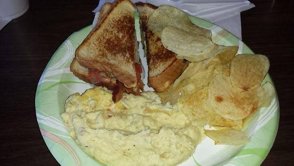 BLT Sandwich with potato salad and chips.