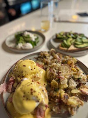 Not so Boring Benedict with avocado and seasonal pesto toast with poached eggs in the back!