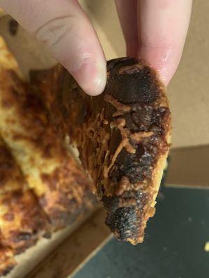 Burnt cheese bread and when I went into to go and ask for a new one I was laughed he has long brown hair and crooked teeth