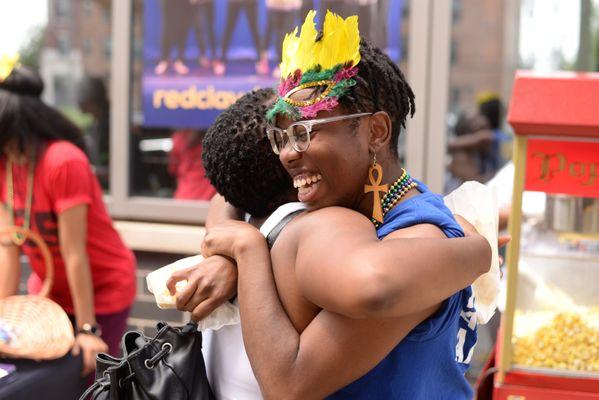 Community members and Staff celebrating at our Mardi Gras in July community event.