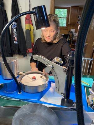 Faceting (cutting) a raw stone.