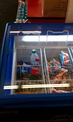 Half finished soft drink bottles in the ice cream fridge.