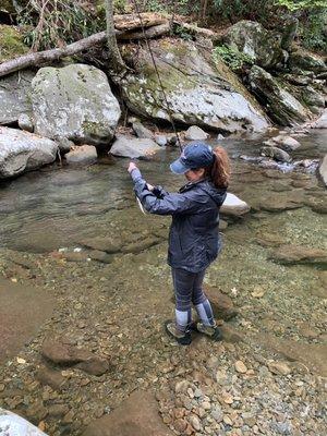 Jessica and unhooking a fish.