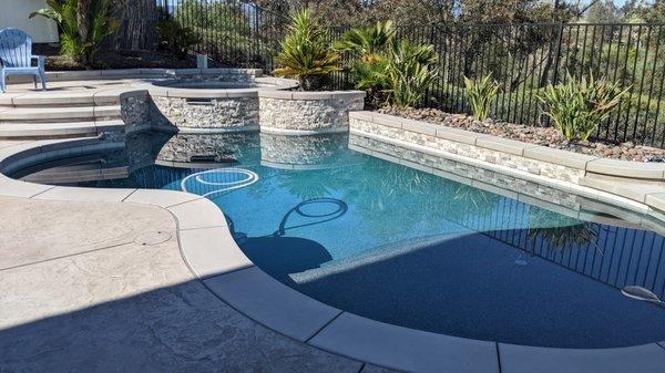 MacBet demo'd our old and replaced with new concrete coping, ledger stone, tile, pebble, and stamped concrete.