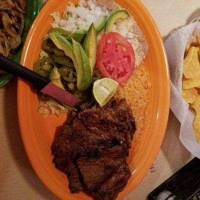 Carne Asada with refried beans, rice, avocado