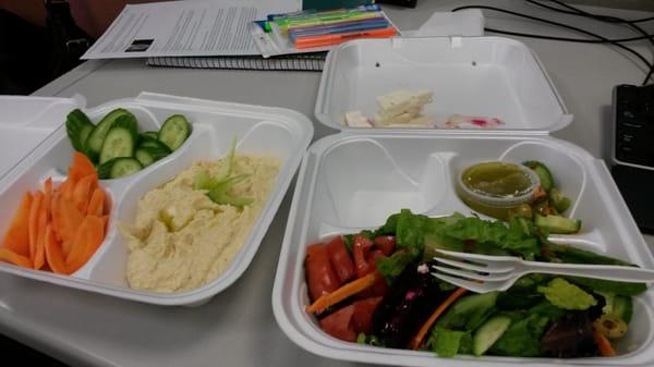 Small Greek salad and side of hummus with fresh veggies instead of bread.  Note the pile of Feta on the lid...plenty of cheese!