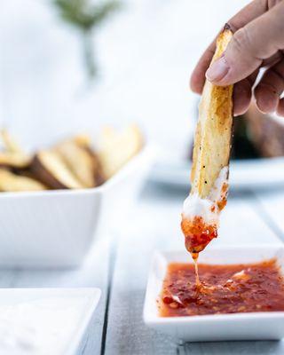 Air-fried potato wedges w/ sour cream and sweet chili sauce