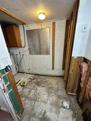 We did demolition to start remodeling the bathroom with black, gray and silver tile.