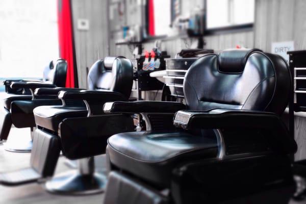 Interior of the shop and some barber chairs. Clean and relaxed atmosphere.