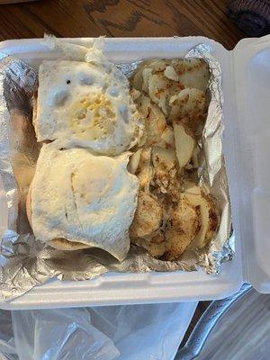 Two eggs on muffin and home fries