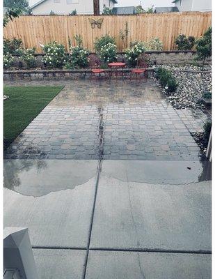 Patio flooding from paver runoff issues due to steep slope.