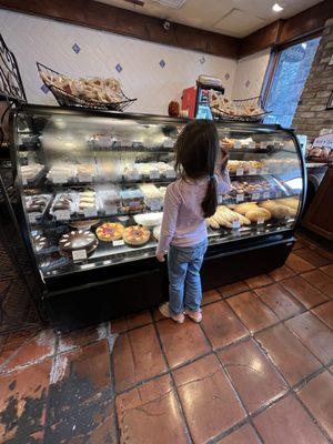 My granddaughter looking at dessert