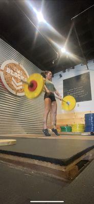 Wooden platform with colored bumper plates