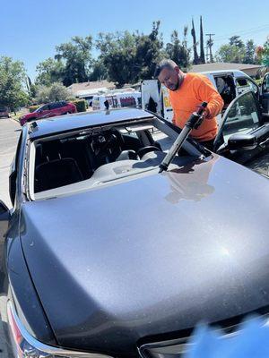 Applying all around some polyurethane before we sit the new windshield.