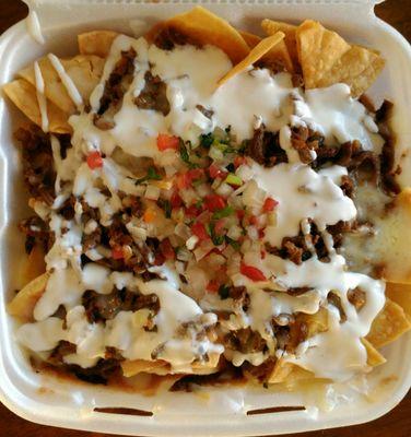 Nachos with melted cheese, sour cream, pico de gallo, and your choice of meat. I ordered to-go.