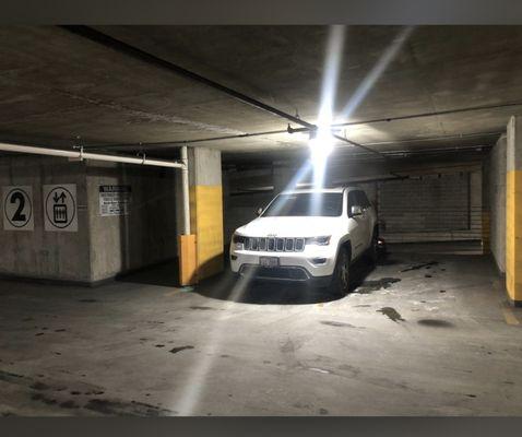 Illegally parked cars in the parking lot and people sleeping in them