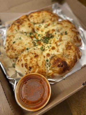 Cheesy garlic bread with sauce on the side