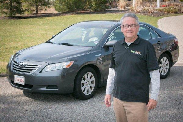 One of our "basic green" Camry hybrids with one of our drivers, Bob T