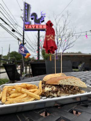 Philly cheesesteak sandwich with fries