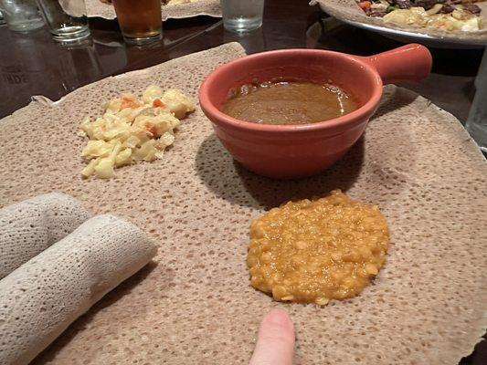 Atakilt wat on the left (which I had ordered as my main but it came as a tiny side), shiro wat in the pot, misir wat on the right.