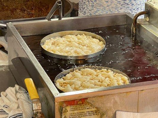 Fresh funnel cakes being made