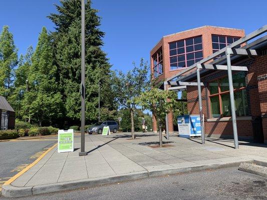 Curbside pickup area under the tall part of the building at the normal entrance in the morning on 29 July 2020.