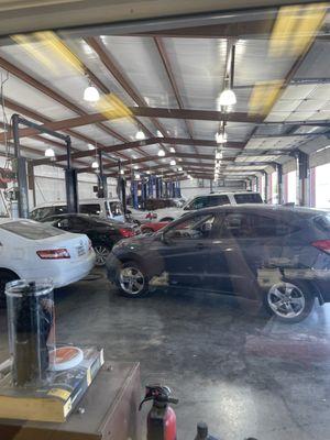 big shop full of cars needing repair.