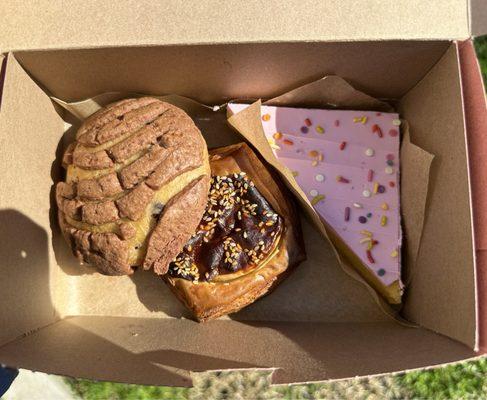 Choco Chunk Concha (L), Imelda's Mole Calabaza Croissant (C), Pink Cake (R)