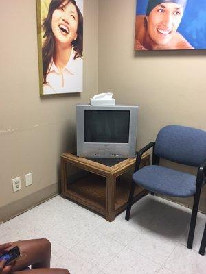 Small waiting room outdated non working tvs