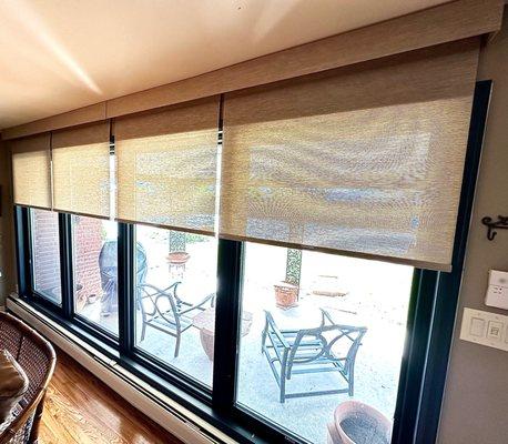 Custom light filtering roller shades with a fabric valence.