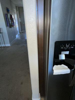 Show the uneven fridge against the molding