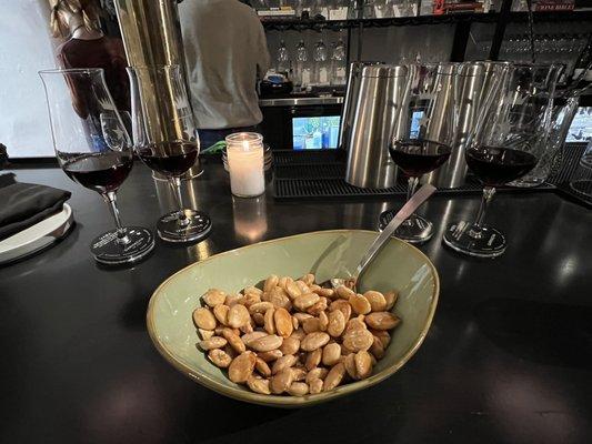 Marcona almonds, served with honey and a spoon, along with a red wine flight