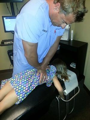 Dr. Ashlock adjusting a child