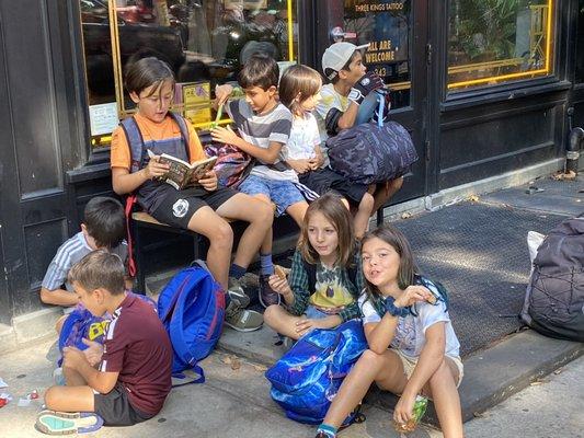 After-school karate class waiting for the bus to go to the dojo.