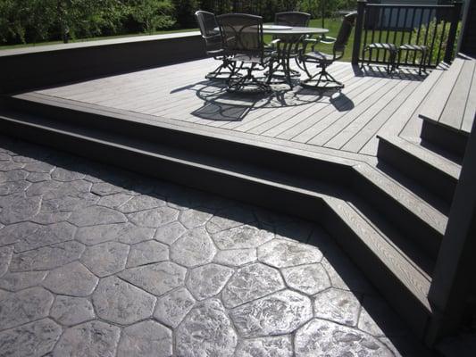 Maintenance free deck extension and stamped patio with fire pit entertaining space below.