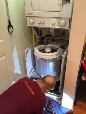 Technician repairing washer.