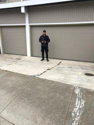 Joe standing next to the new, installed flush design garage doors in San Francisco CA