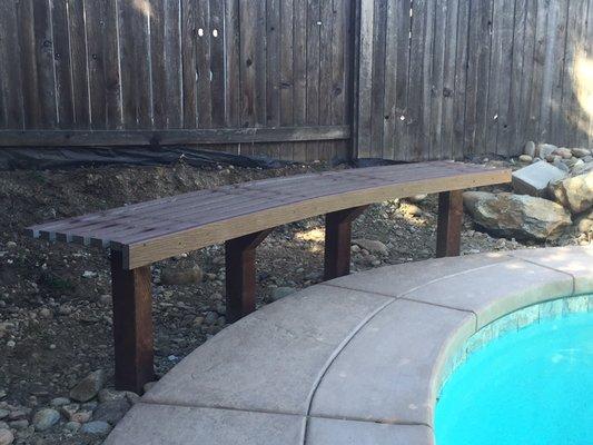 The concrete extension to the pre-existing pool sides shares a beautiful bench for all to share.