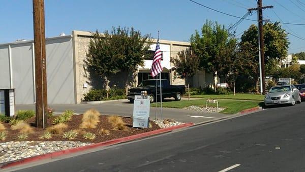 The city made us remove the Precise flag banner. Now We have an American flag flying on Walsh ave. So just look for the Flag.